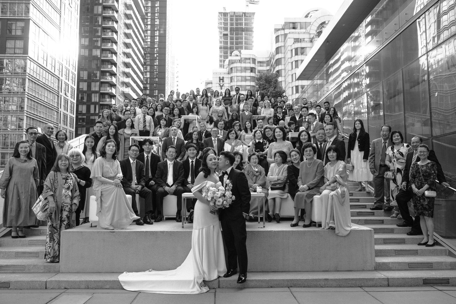 Black and white photo of a wedding ceremony in a traditional church with ornate altar decorations.