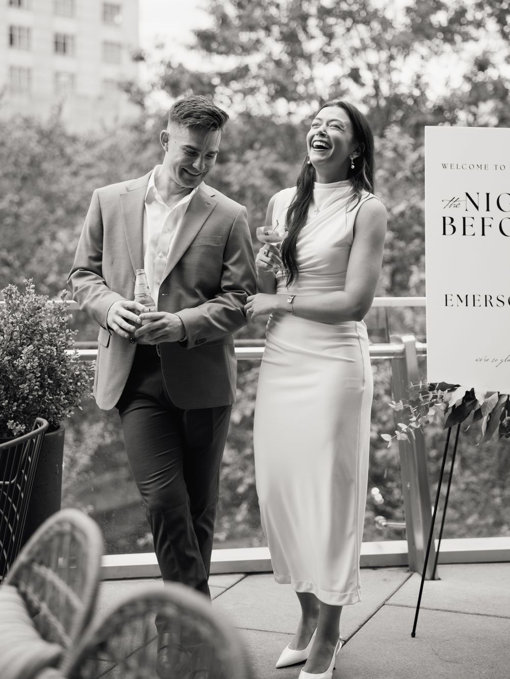 Couple sharing a candid laughing moment at their engagement or wedding event.
