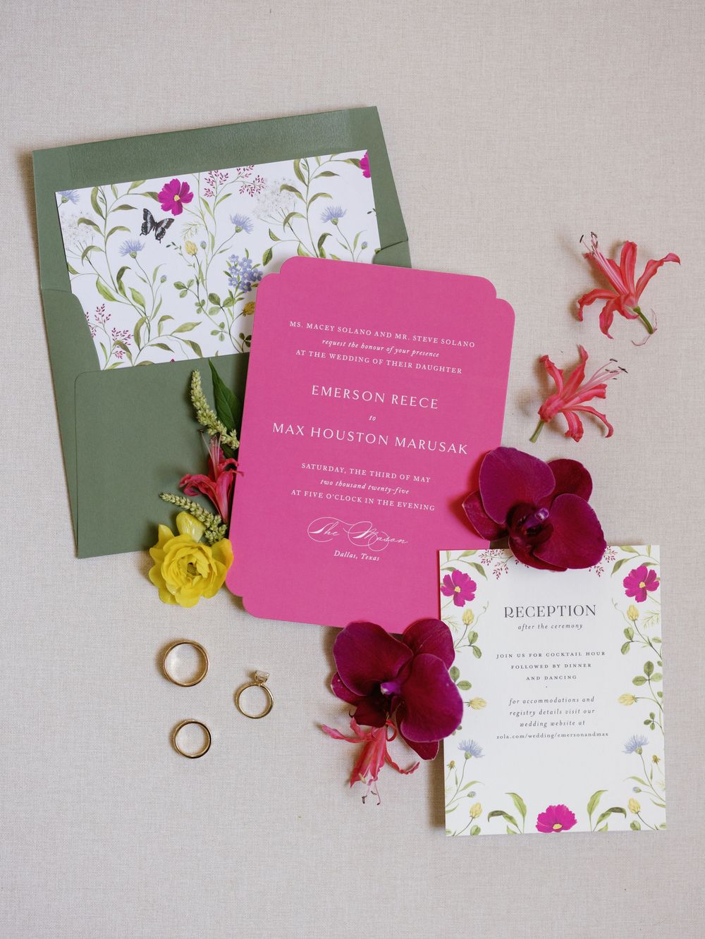 Pink and white wedding invitation suite with floral envelope liner, rings, and vibrant orchid decorations.