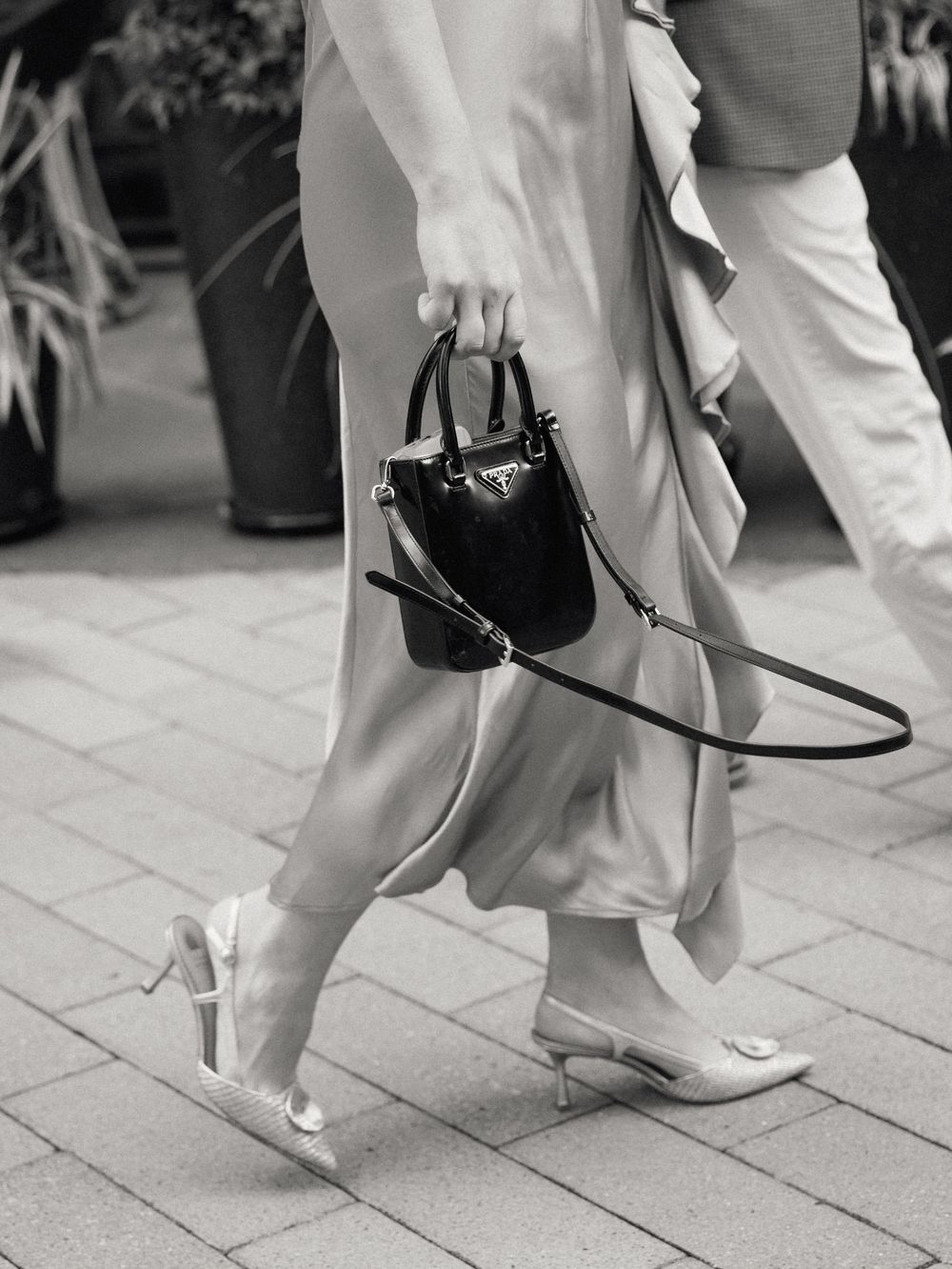 Black and white close-up photos of feet and formal attire during an elegant event.