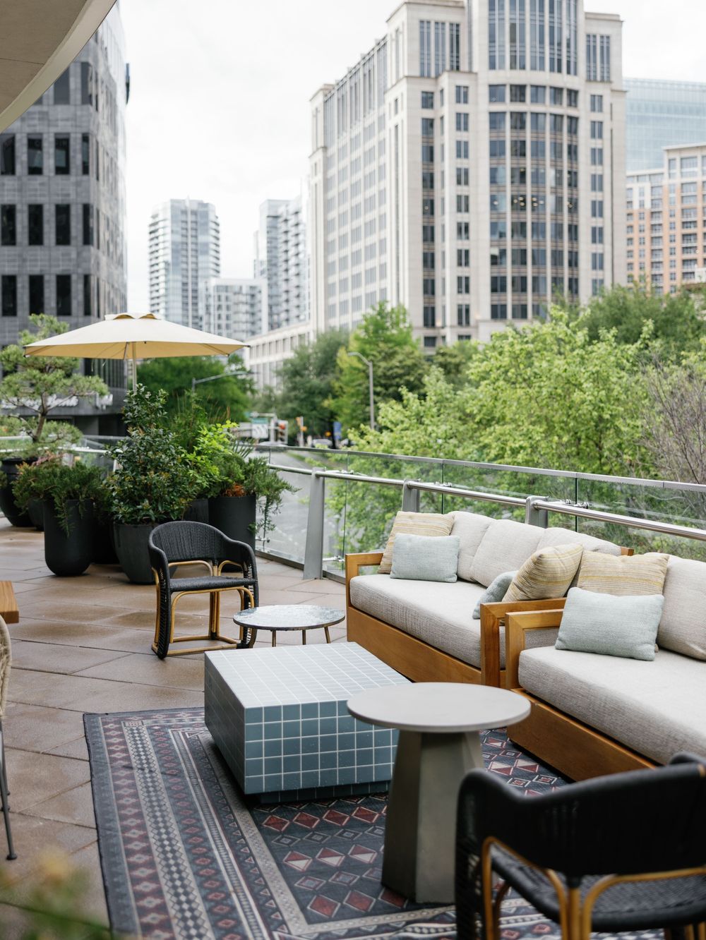 Modern rooftop terrace with comfortable outdoor seating and city skyline views.