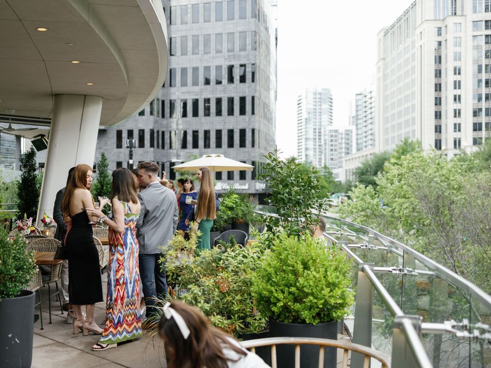 Urban rooftop terrace with city skyline views and modern architectural details.