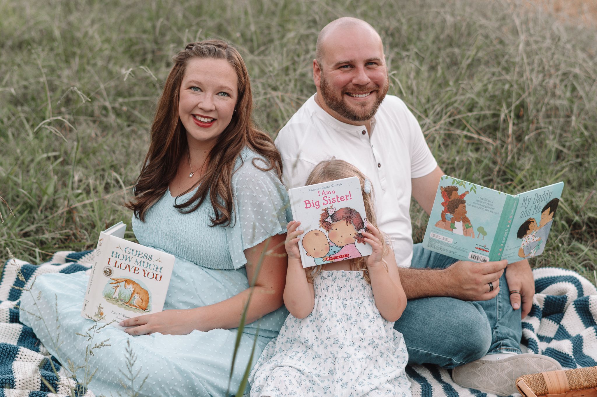 Playful family moments captured on a striped blanket during an outdoor photoshoot.