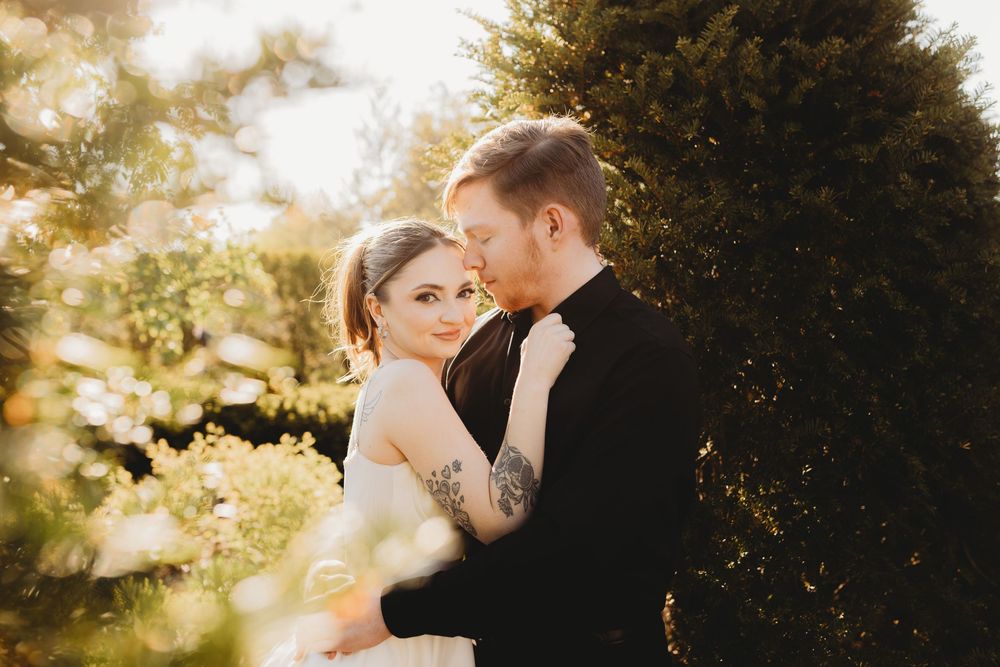 Golden hour wedding portrait capturing romantic moment in garden setting.