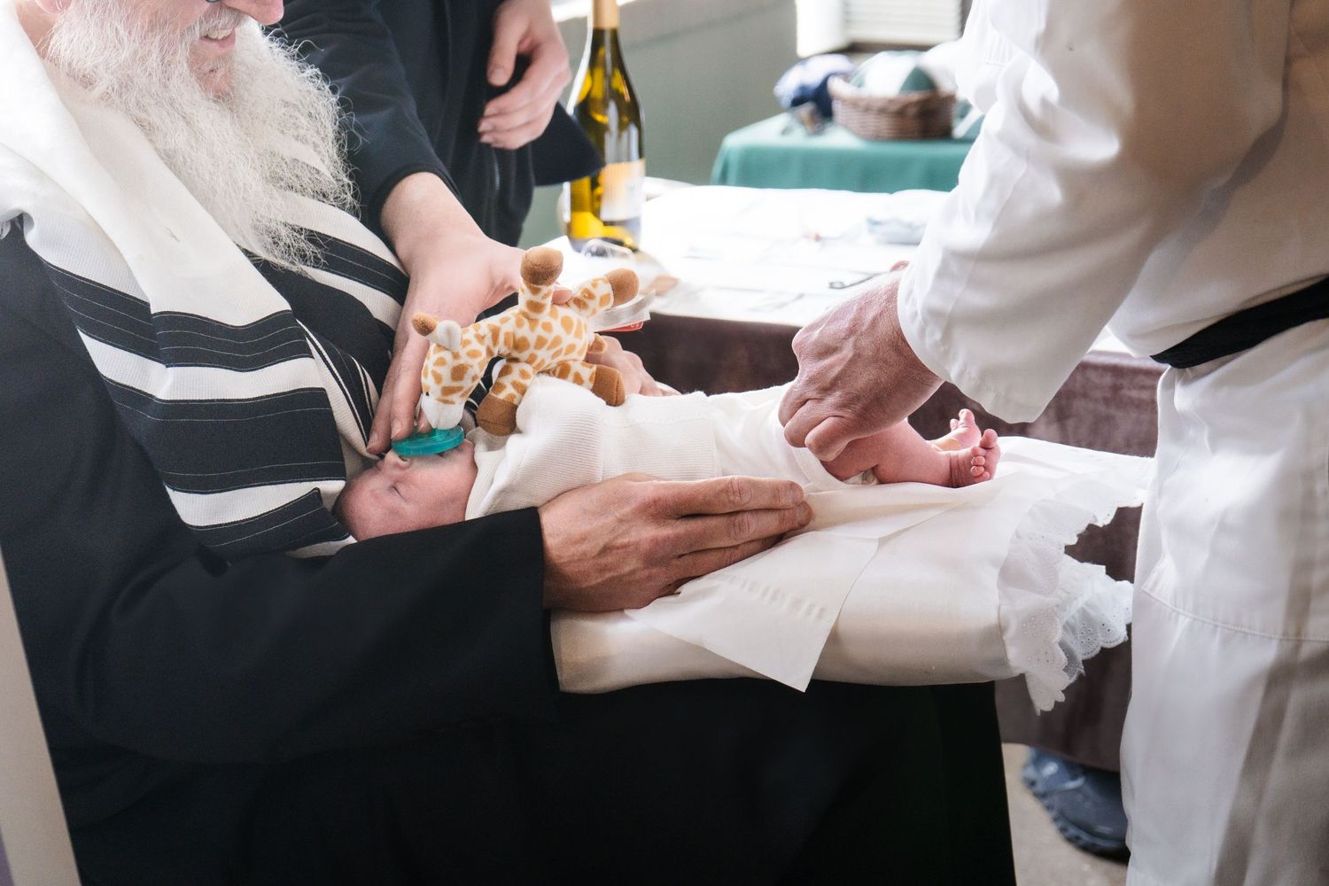 Hands exchanging ceremonial items during a religious ritual.
