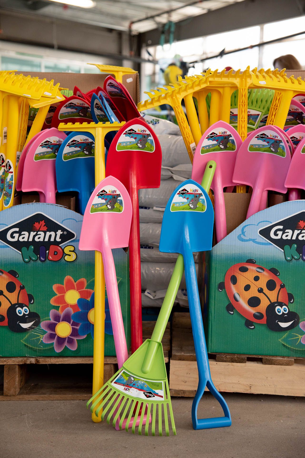 Colorful kids garden tools including rakes, shovels and brooms with fun ladybug and flower designs on display at Bradford Greenhouse