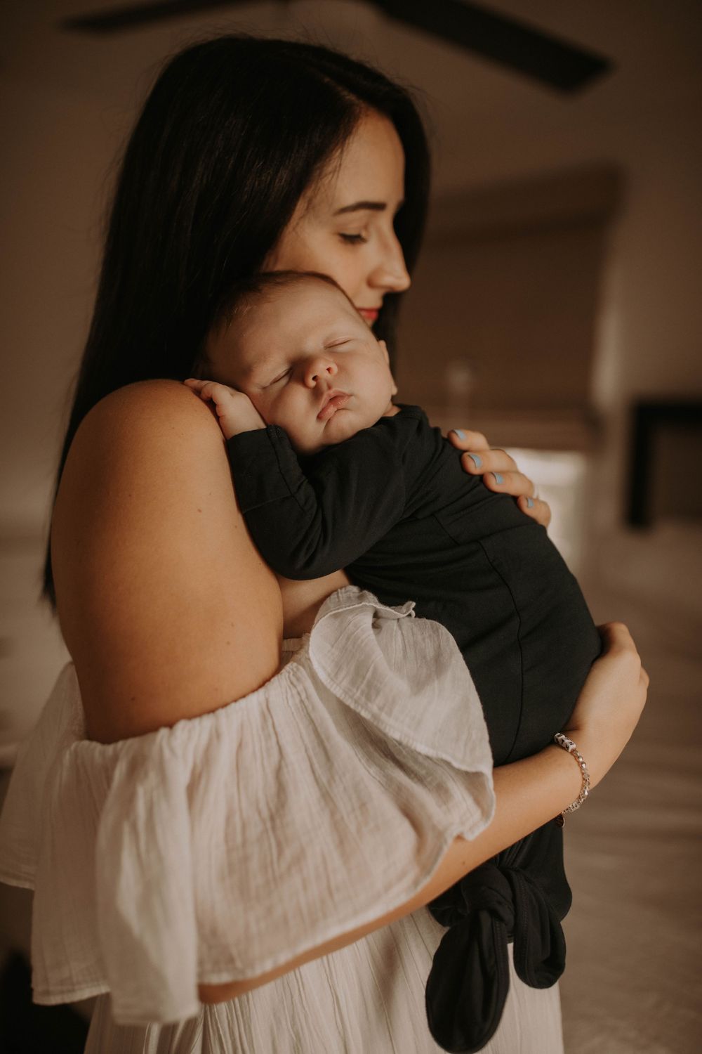 A series of intimate embraces between two people wearing white and black clothing in a moody setting.