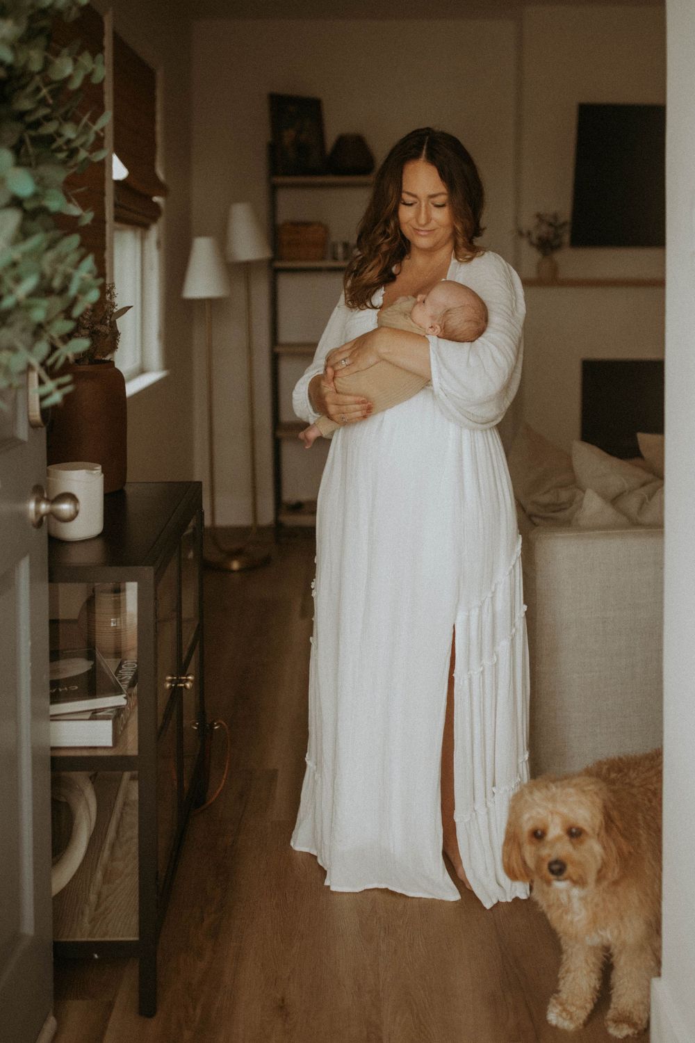 A series of intimate indoor photos showing someone in white clothing with a goldendoodle dog in a cozy home setting.