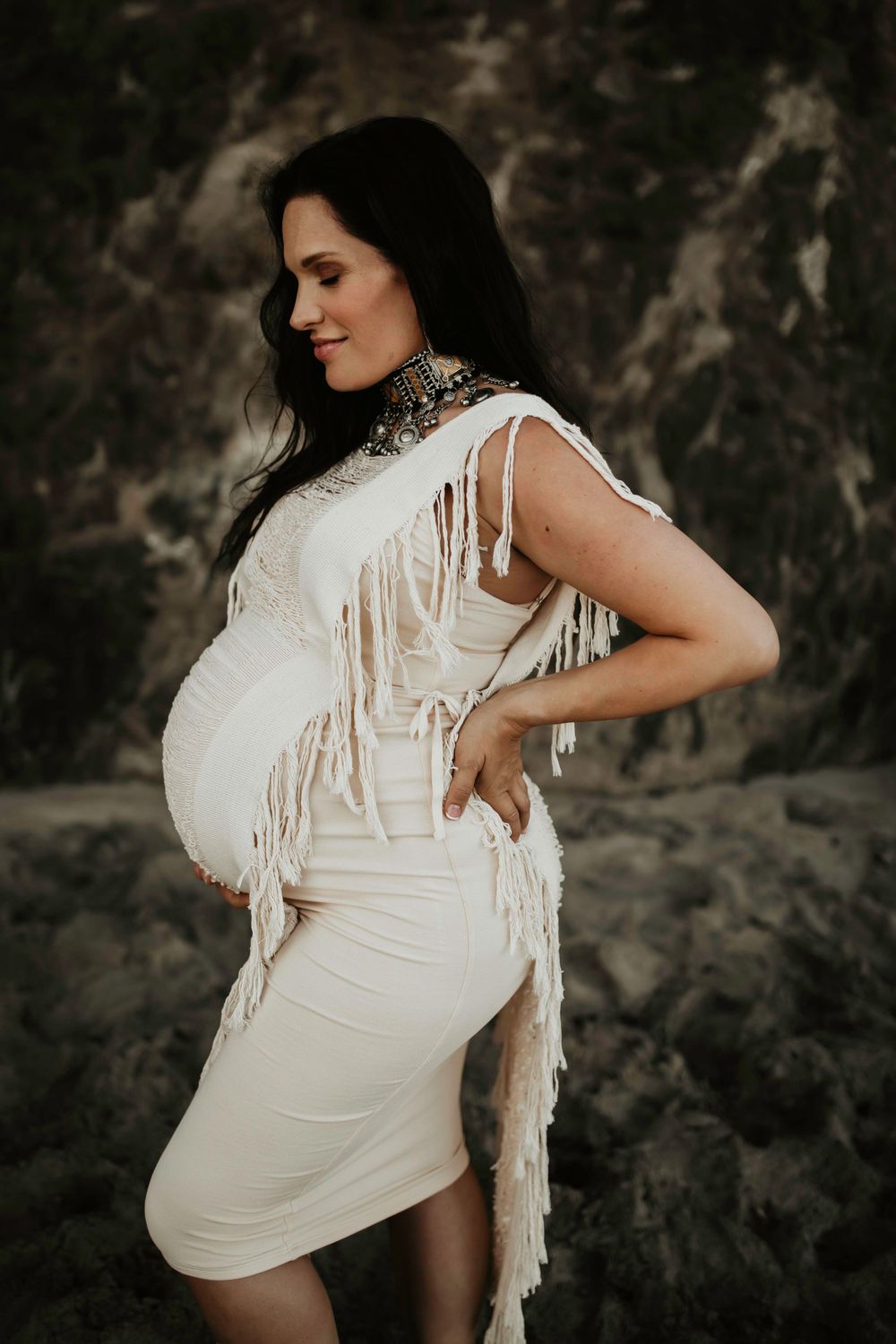 A series of maternity photos showing a woman in white against a dark textured background.