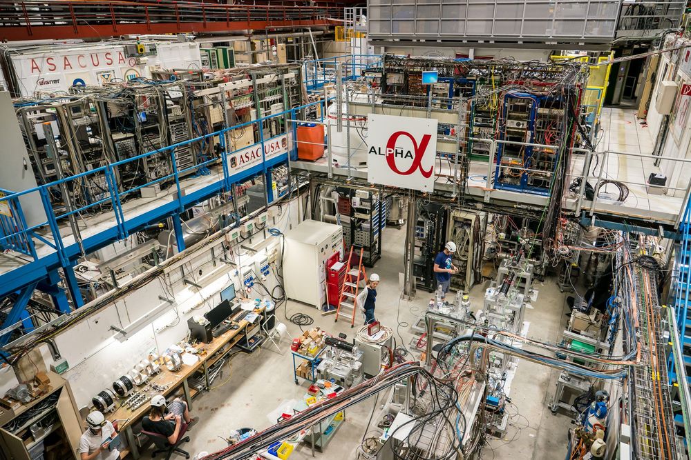 Large scientific experimental facility with complex machinery and equipment arranged in rows for particle physics research.
