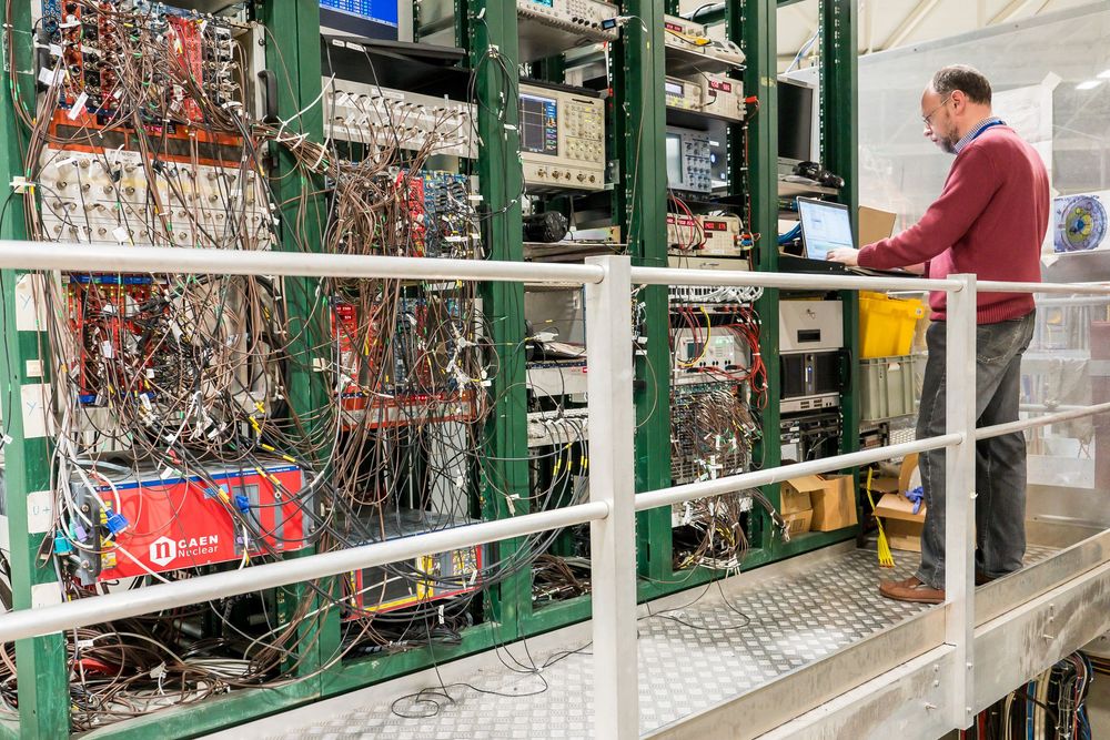 Large warehouse rack filled with neatly organized copper wire recycling materials and electronic components.