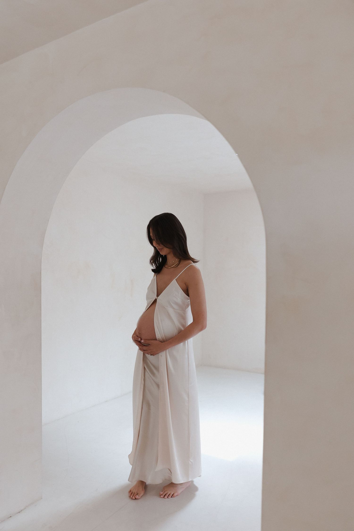 Studio maternity pictures highlighting baby bump and natural posing in California Studio