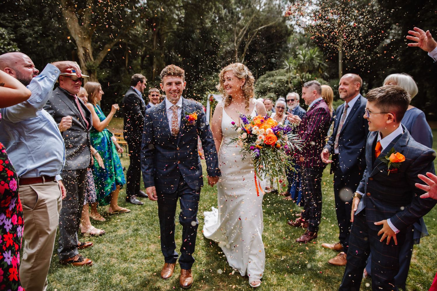 Dorset candid wedding photographer. Tipi wedding Dorset. Outdoor wedding Dorset. Abbotsbury Subtropical Garden Wedding. Navy suit Dorset.