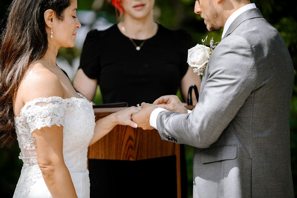 A bride and groom share their first dance together during a wedding reception in an outdoor garden setting.