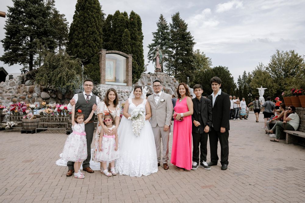 A panoramic collage of wedding party photos taken outdoors on a sunny day with trees and stone architecture in view.