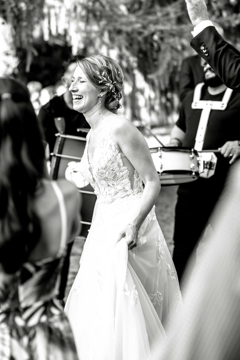 Black and white photo capturing a candid moment of pure joy during a wedding celebration.