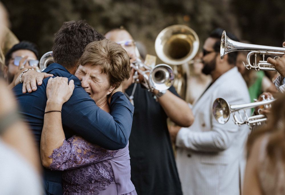A joyful entertainment celebration with dancing and live musicians playing brass instruments at an event.