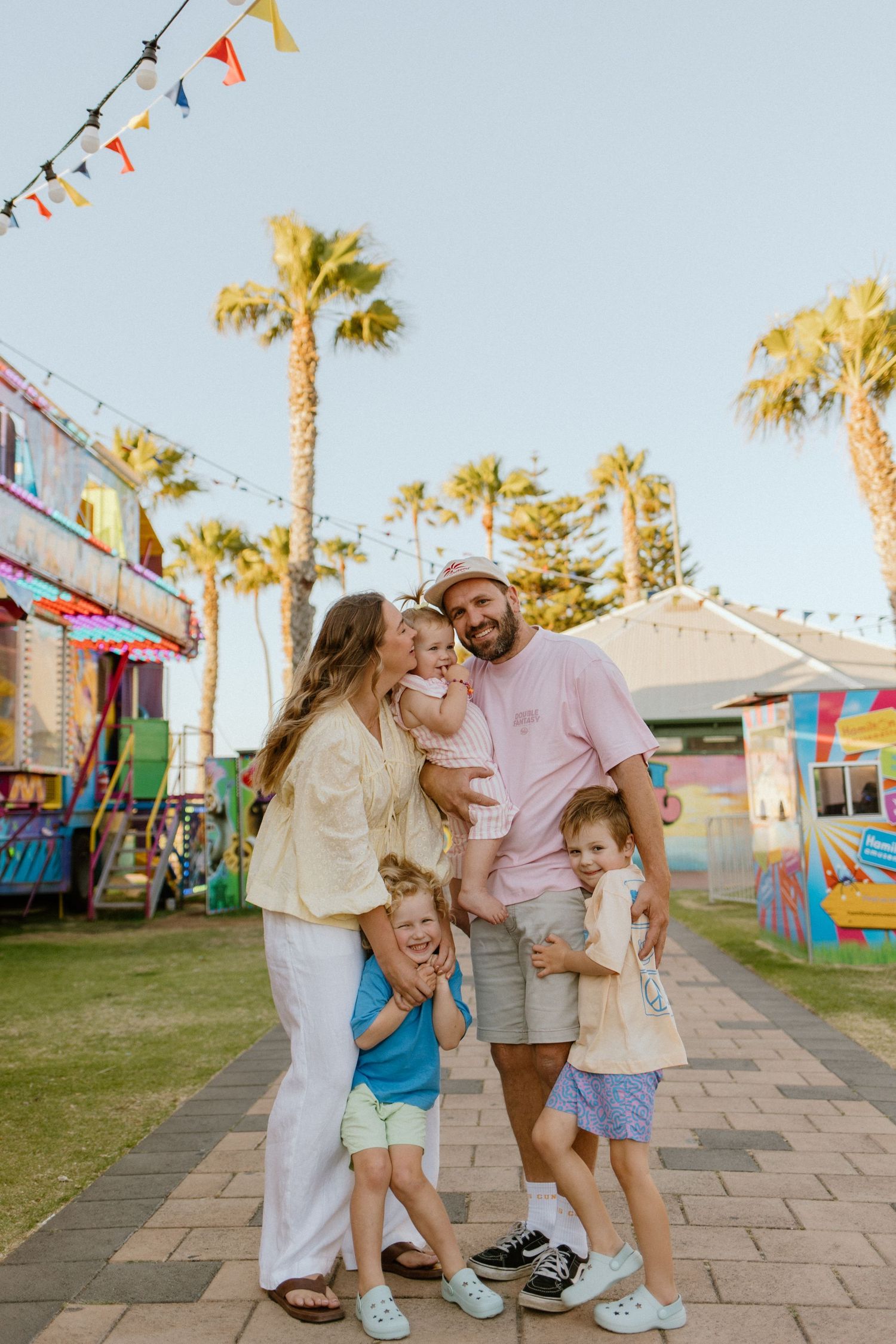 A young Adelaide family enjoys the fun and games at the Semaphore Foreshore Carnival on a warm summer evening with Lauren Lunn Photography.