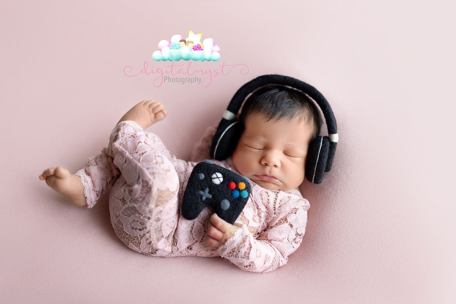Newborn baby wearing pink sleeper and black headphones lying on pink backdrop in multiple artistic poses.
