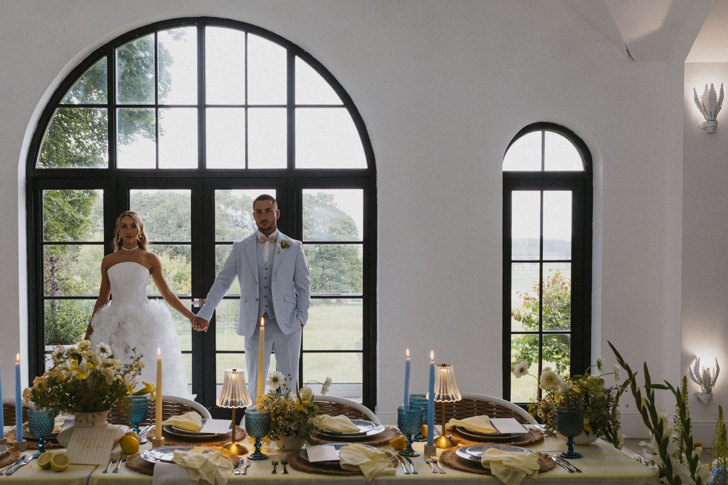 Wedding party celebrating with champagne in an elegant room with vintage decor.