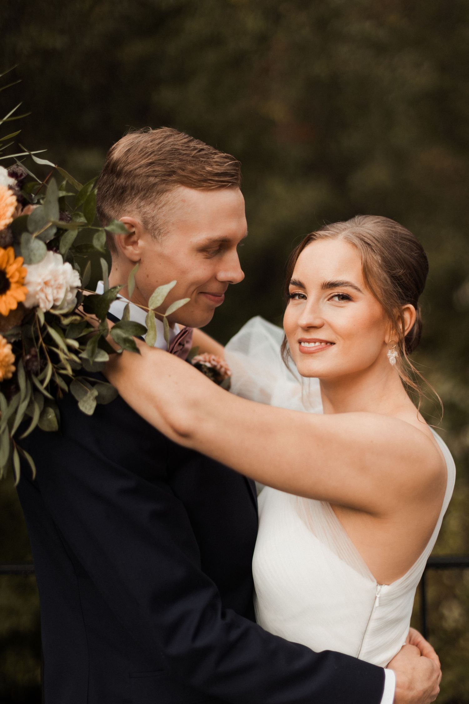 Intimate wedding moment captured between couple during autumn outdoor photoshoot.