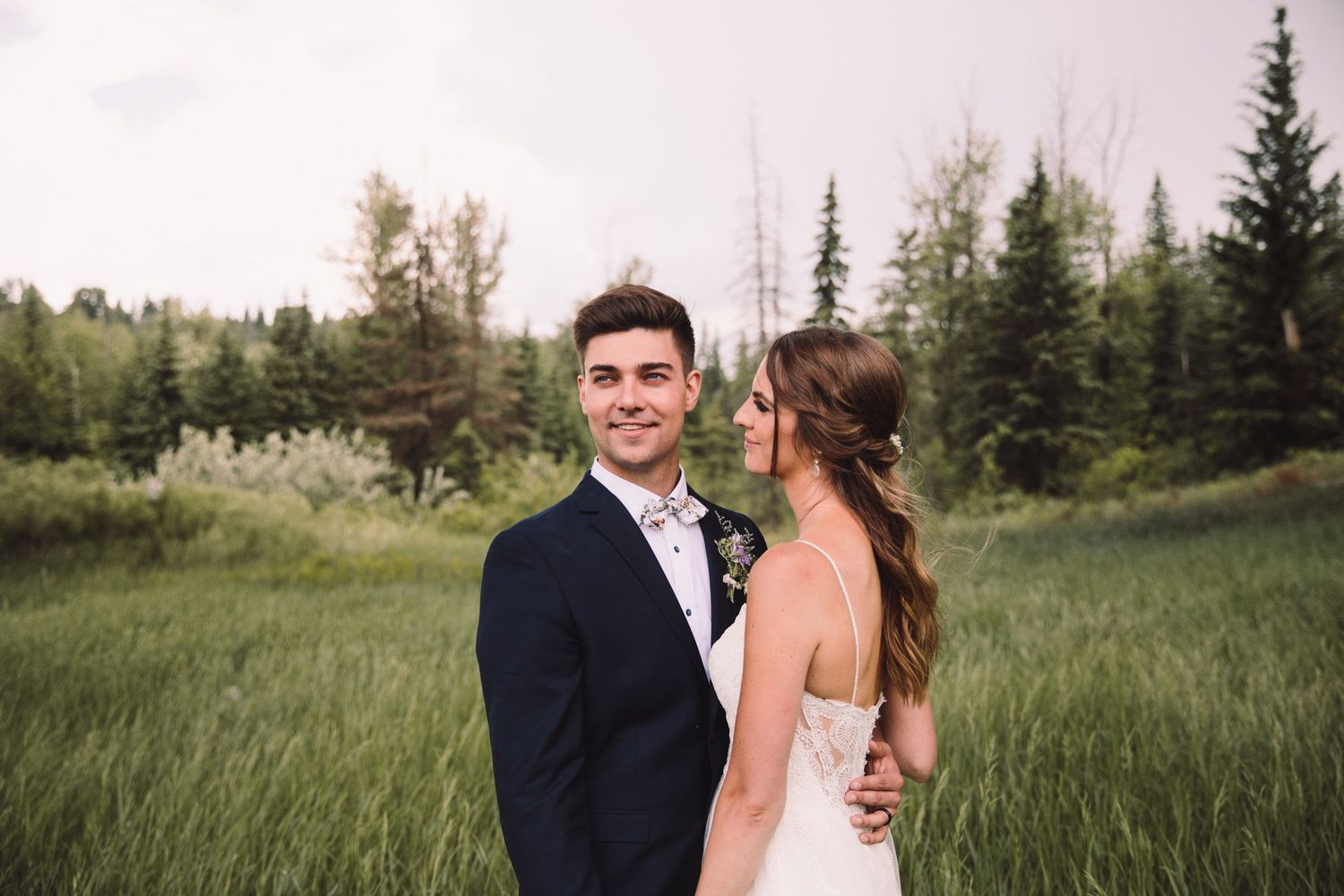 Elopement Photographer - Smiling Bride and Groom standing in a field