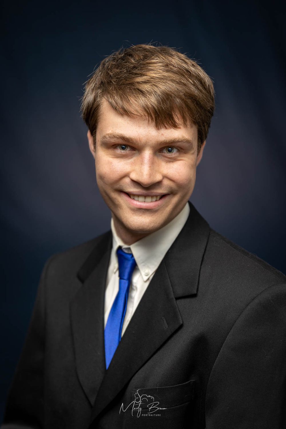 Corporate man in suit sitting studio portrait