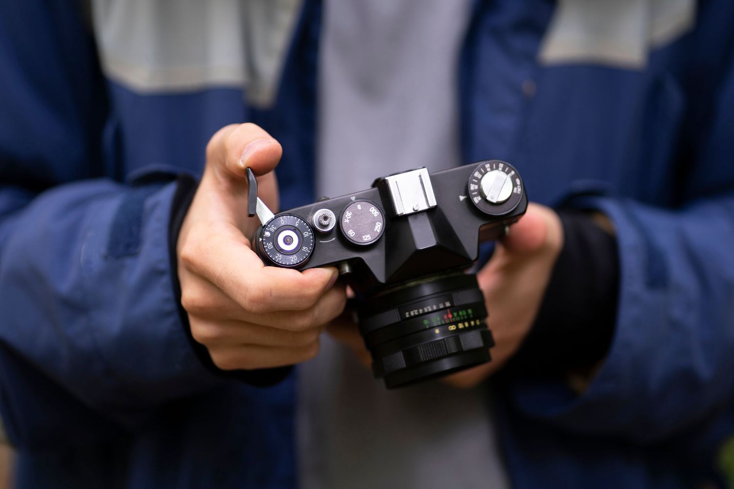 Close-up views of someone holding and examining various camera equipment and controls in a sequence of photos.