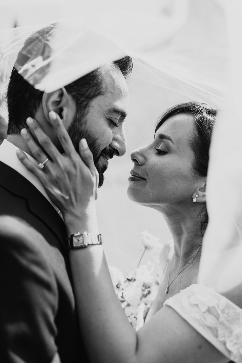 A series of black and white romantic wedding photos showing tender moments between newlyweds.