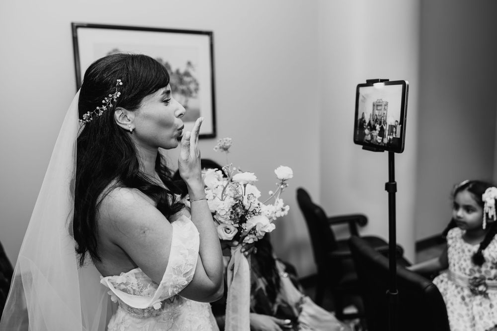 A bride shares a tender moment with a small toddler while getting ready for her wedding day.