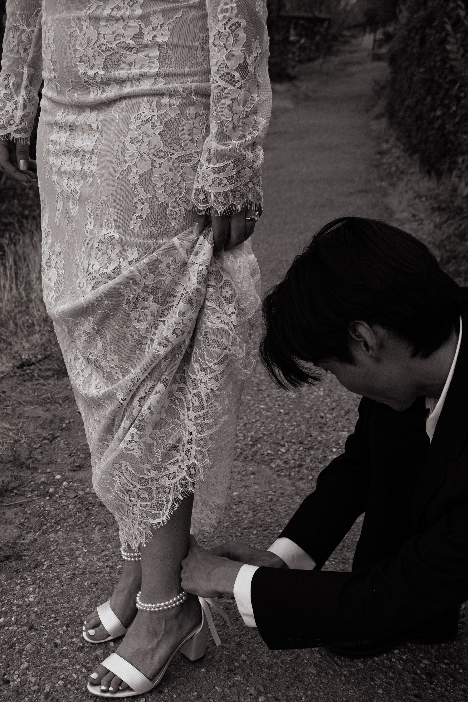 Groom ties brides shoe