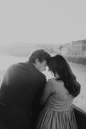 A black and white photo sequence shows a couple embracing and leaning in together in a romantic moment.