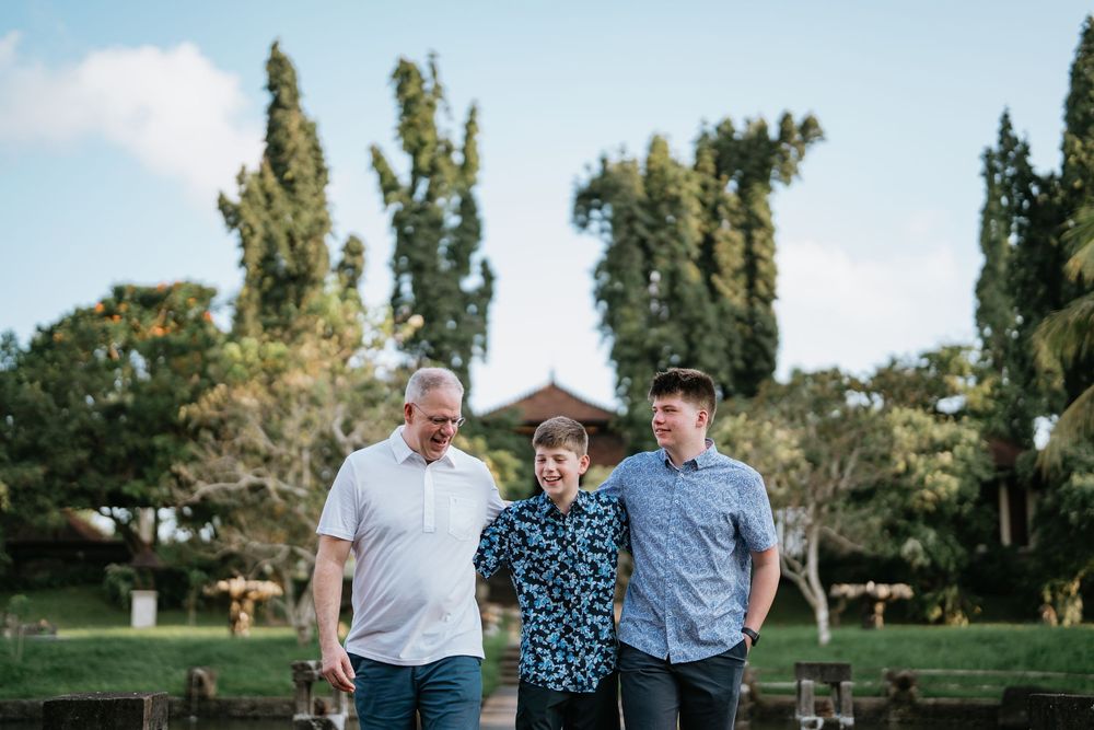 Group portrait session in a sunny outdoor park setting.