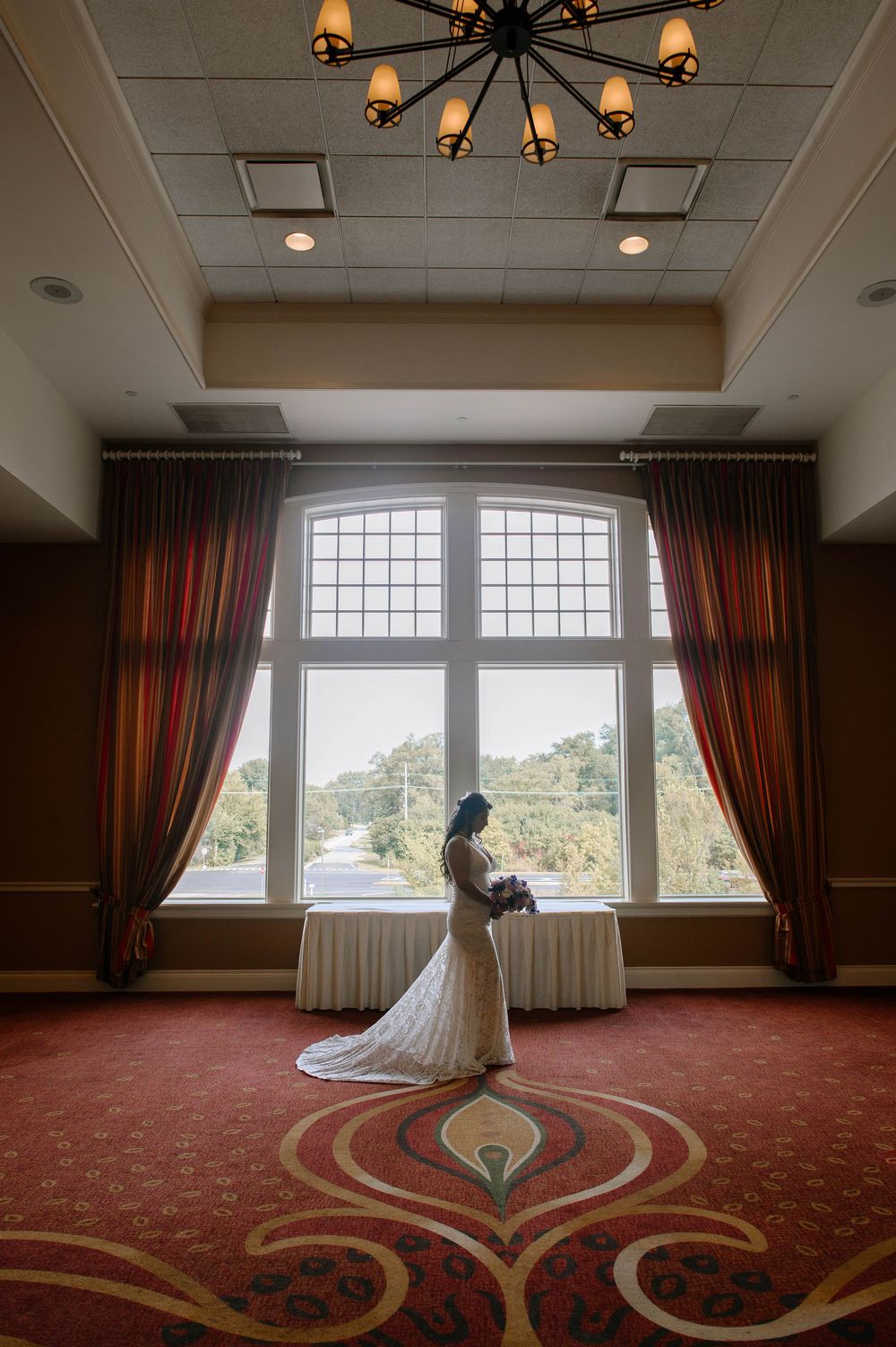 A progression of window views in an elegant room with red carpeting and ornate design elements.