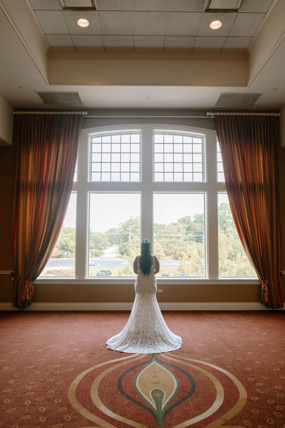 Six sequential photos show a white wedding dress on display against a carpeted room with large windows and brown curtains.