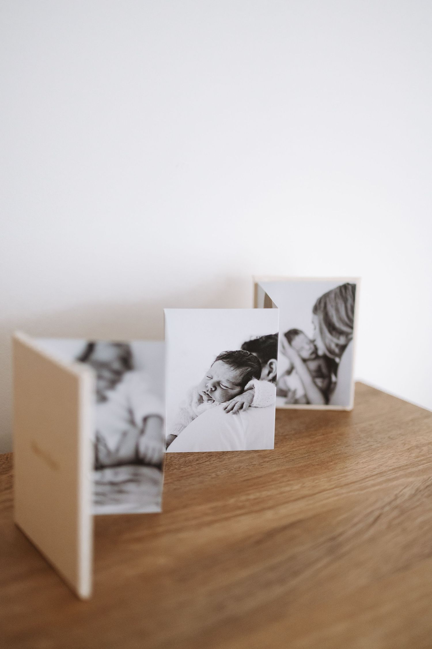 Wooden shelf display featuring decorative items including Coca-Cola can, photo frames, and white ceramic containers.