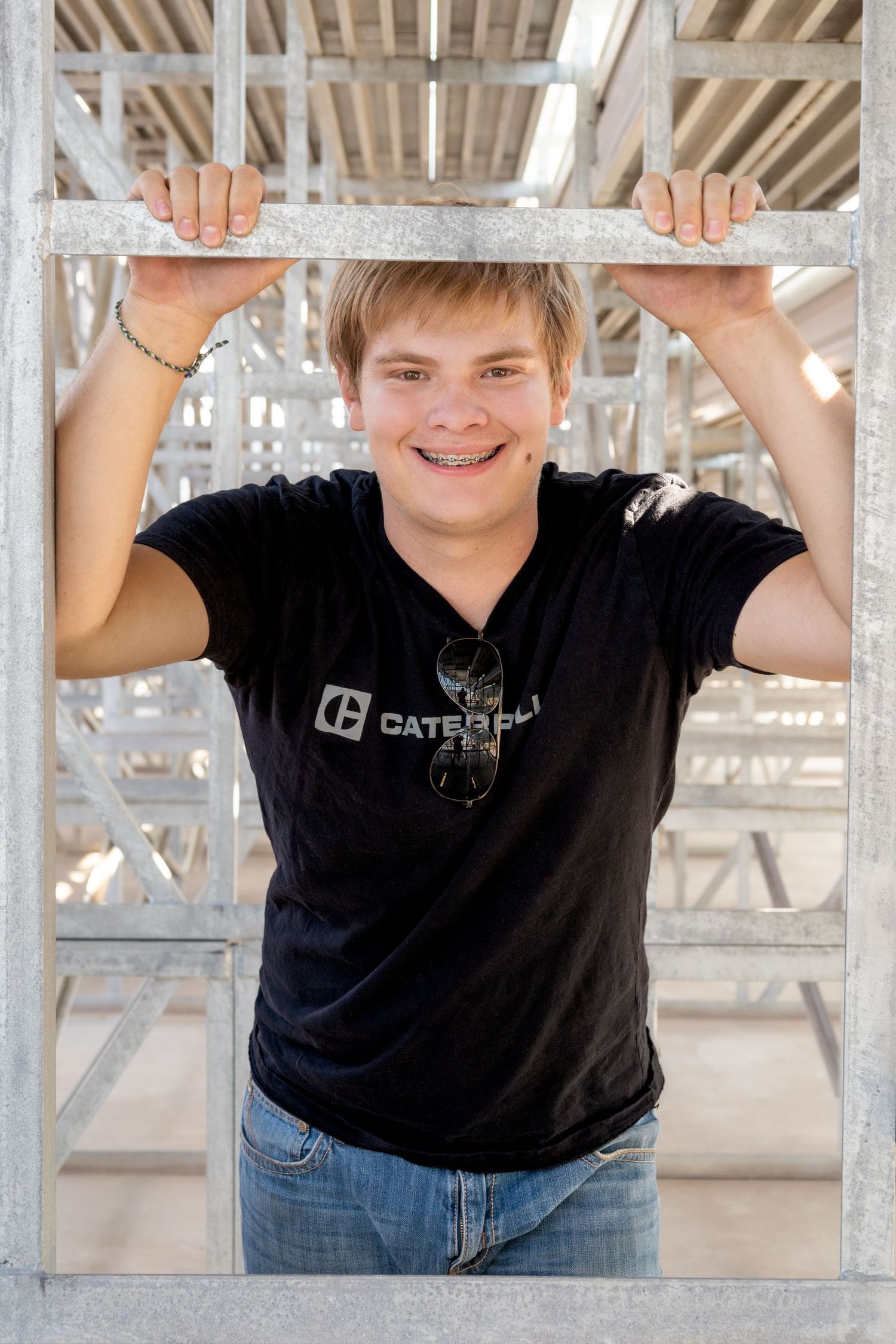 Senior boy posing in casual cloths with bright airy feeling in dynamic background.