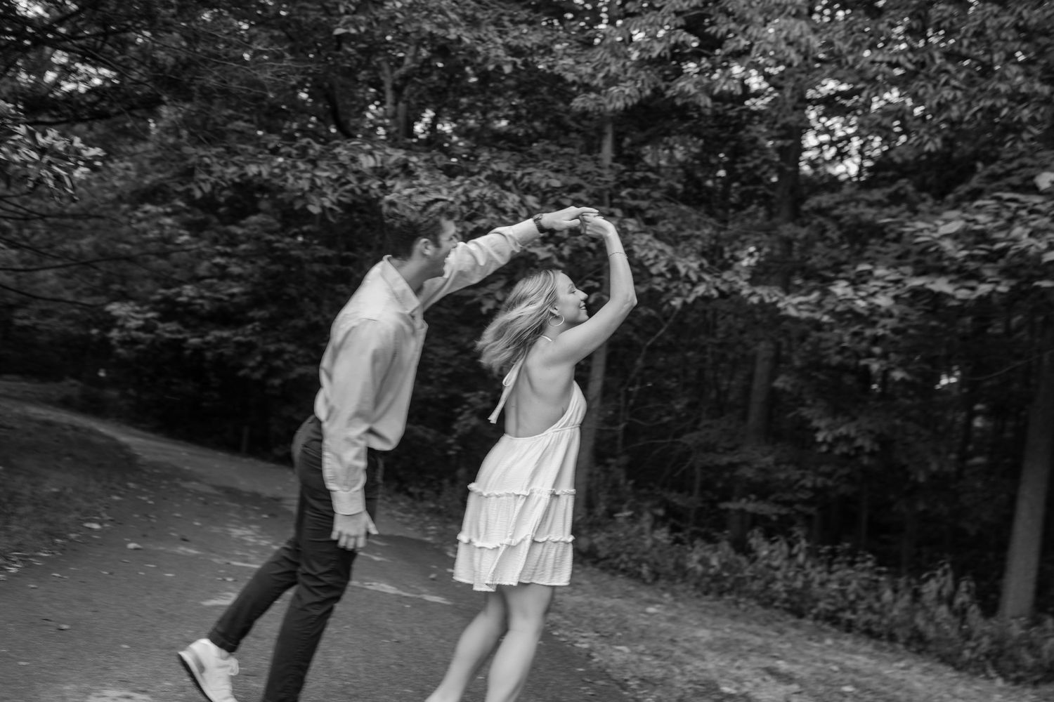 Black and white photos showing romantic dance poses in an outdoor setting.
