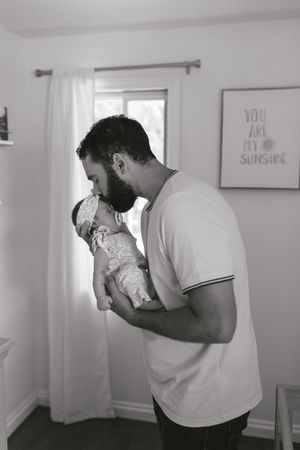 A series of four similar grayscale images showing a person in a white shirt embracing someone in a gentle, emotional moment.
