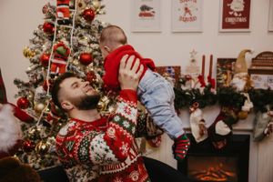 A joyful moment captured during Christmas celebrations with holiday decorations.