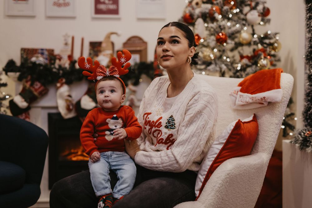 Holiday photo showing festive Christmas decor and gathering in decorated living room.