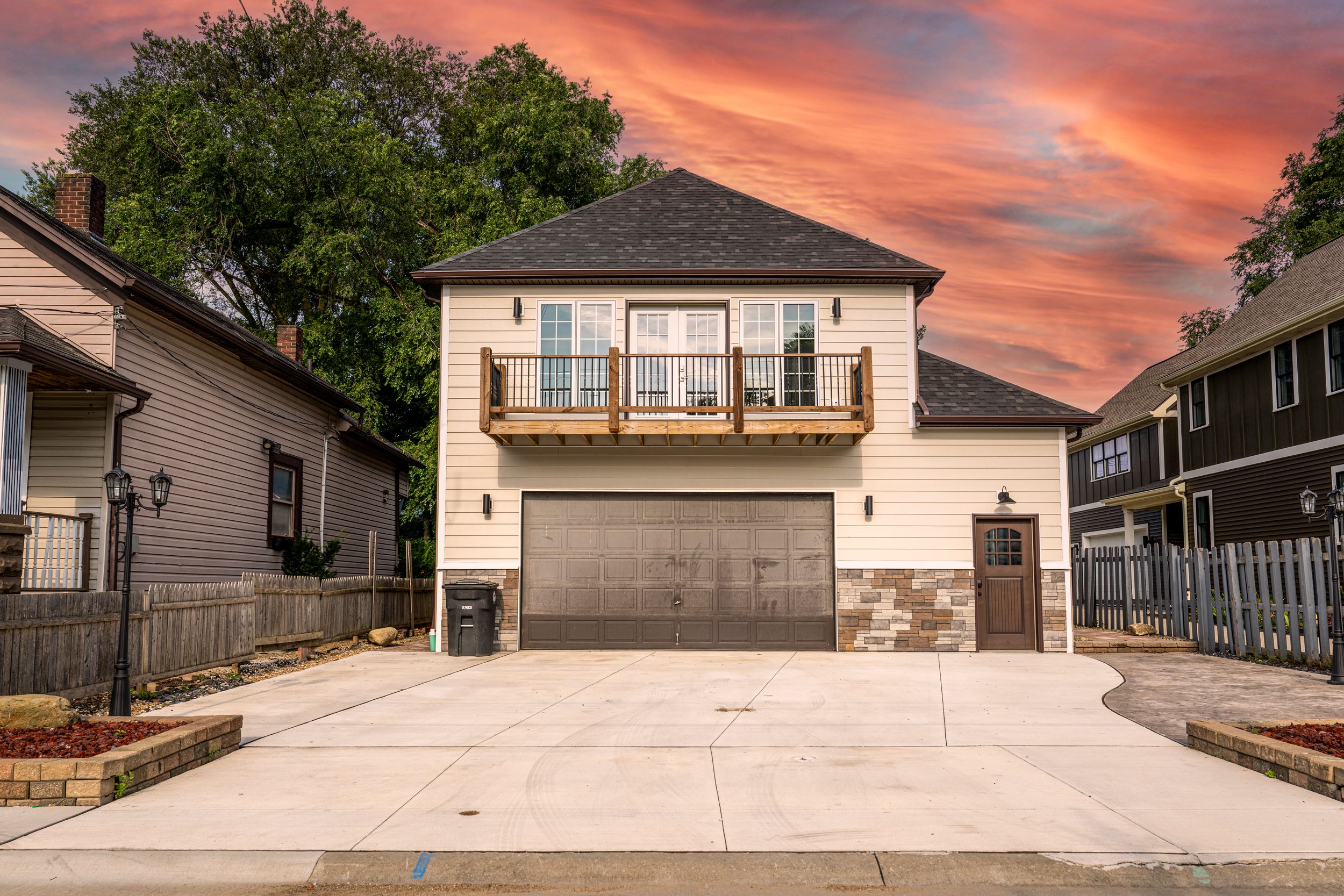 A series of concrete driveways at different residential homes shown during sunset with colorful orange and pink skies.