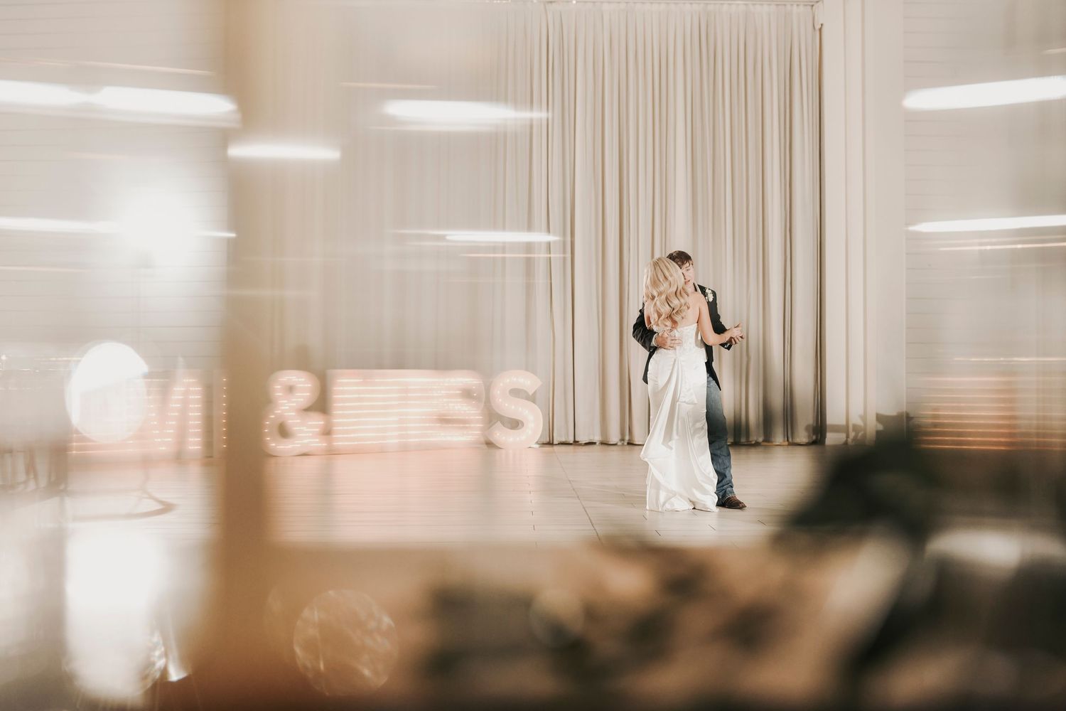 Newlyweds dancing together during elegant wedding reception