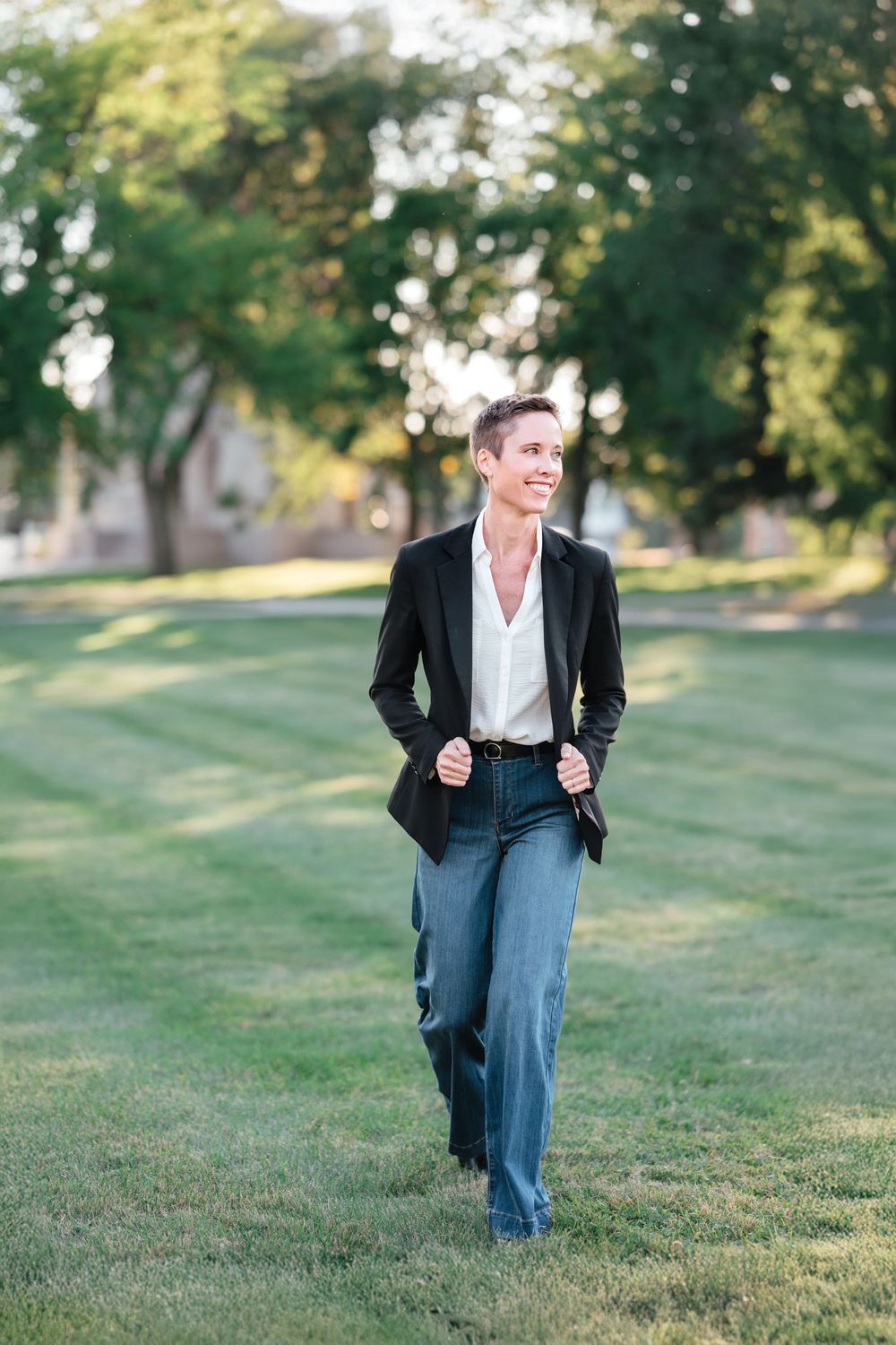 Professional headshot of a business woman wearing denim with natural light and clean editing in Brookings, SD.