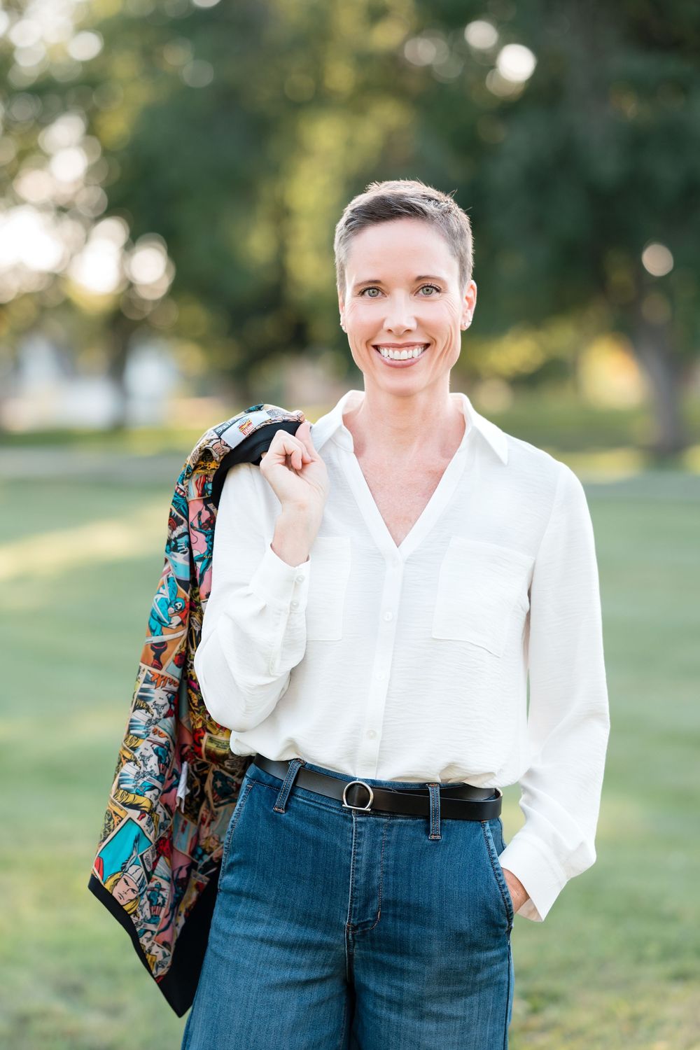 Professional headshot of a business woman wearing denim with natural light and clean editing in Brookings, SD.