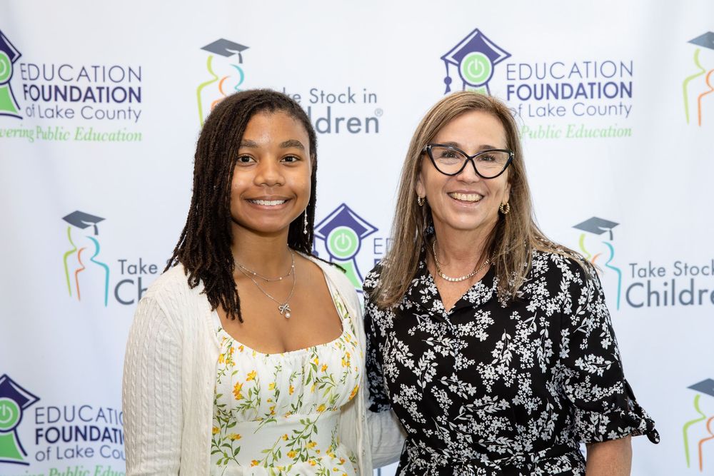 Two women smiling together at an Education Foundation of Lake County Take Stock in Children event.