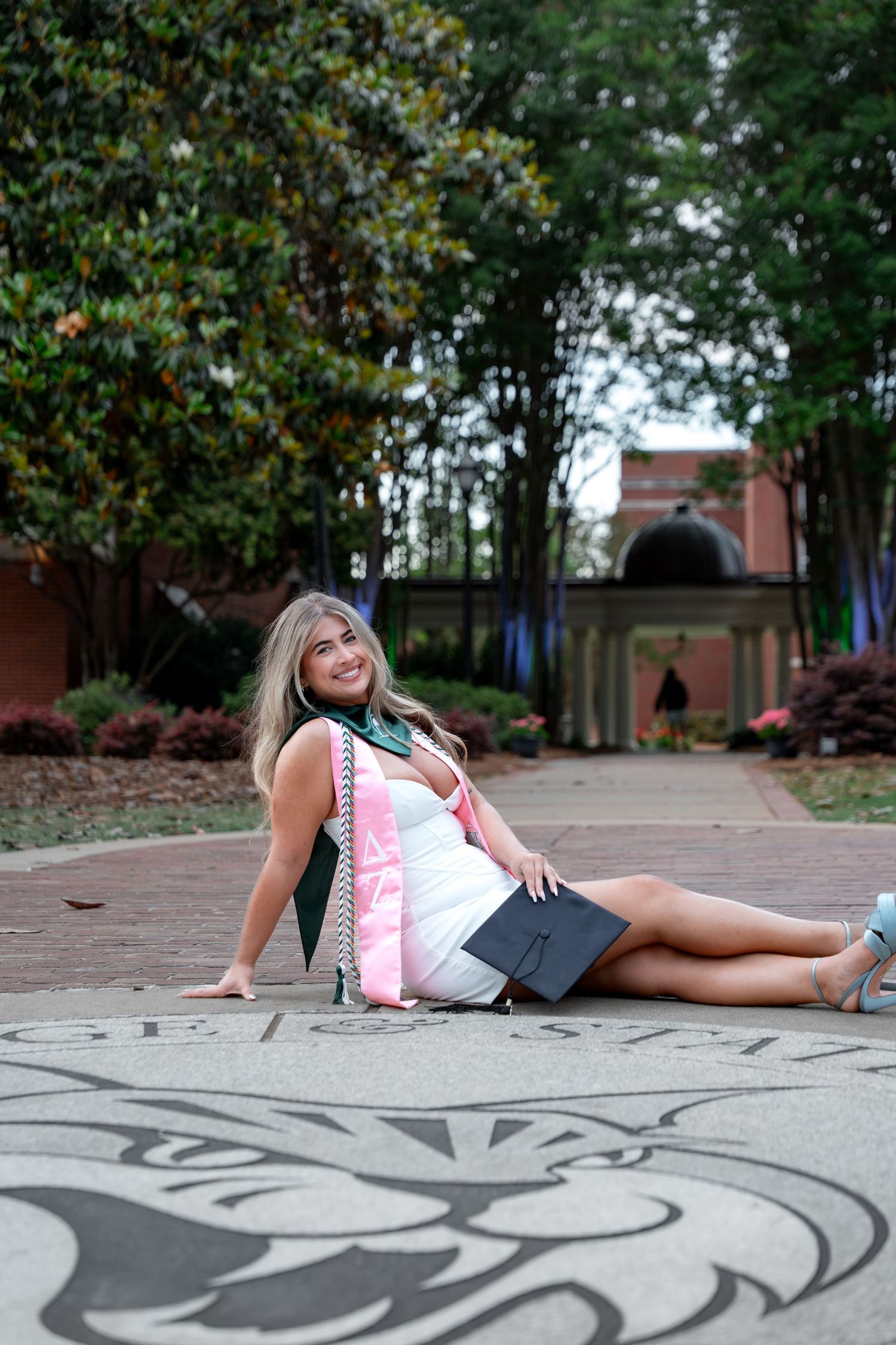 Georgia College graduation solo photos in front of the gcsu crest, one of the classic spots on campus