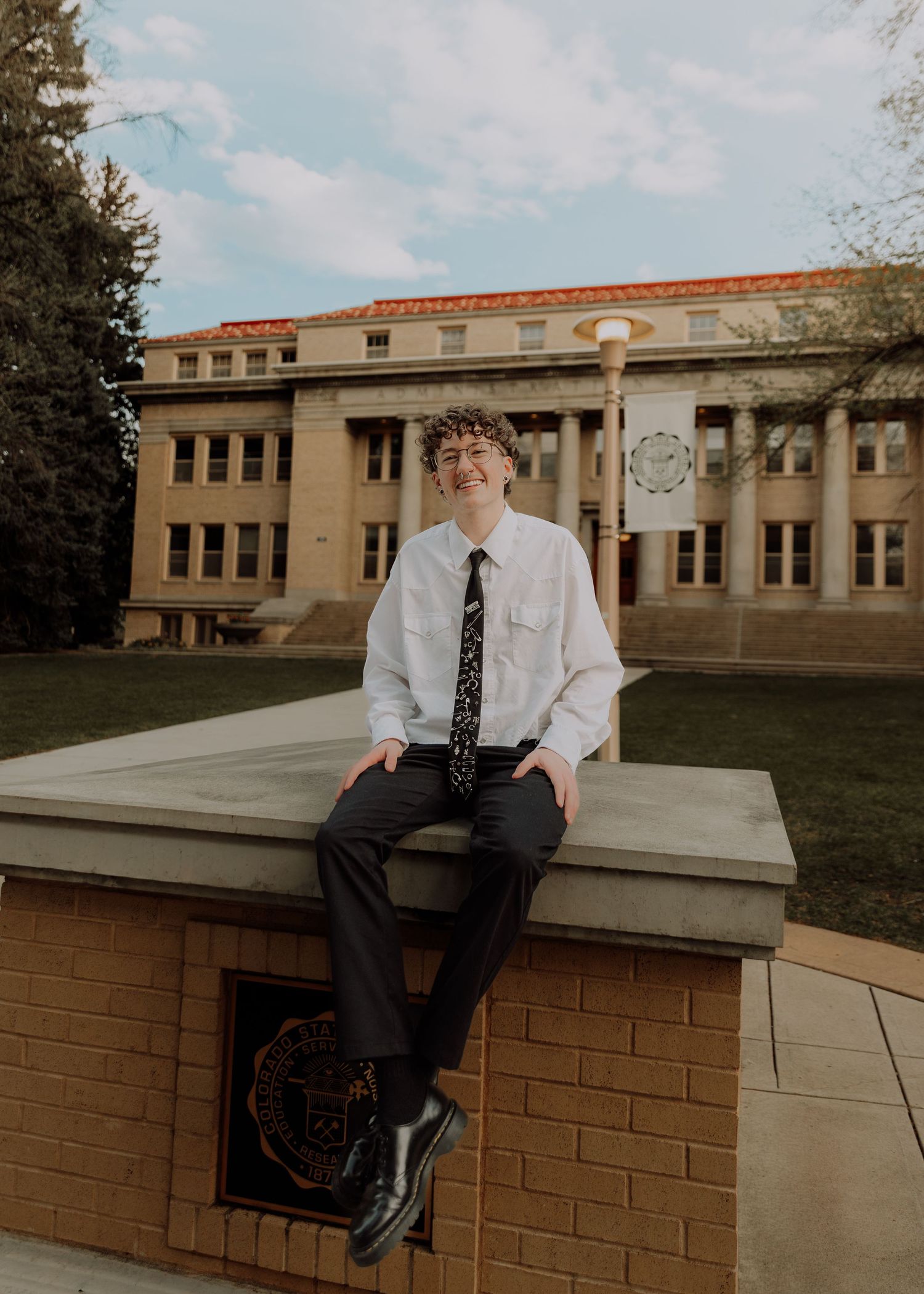 Boy sits and poses for graduation photos at CSU (Colorado State University) graduation photos in Fort Collins, Colorado