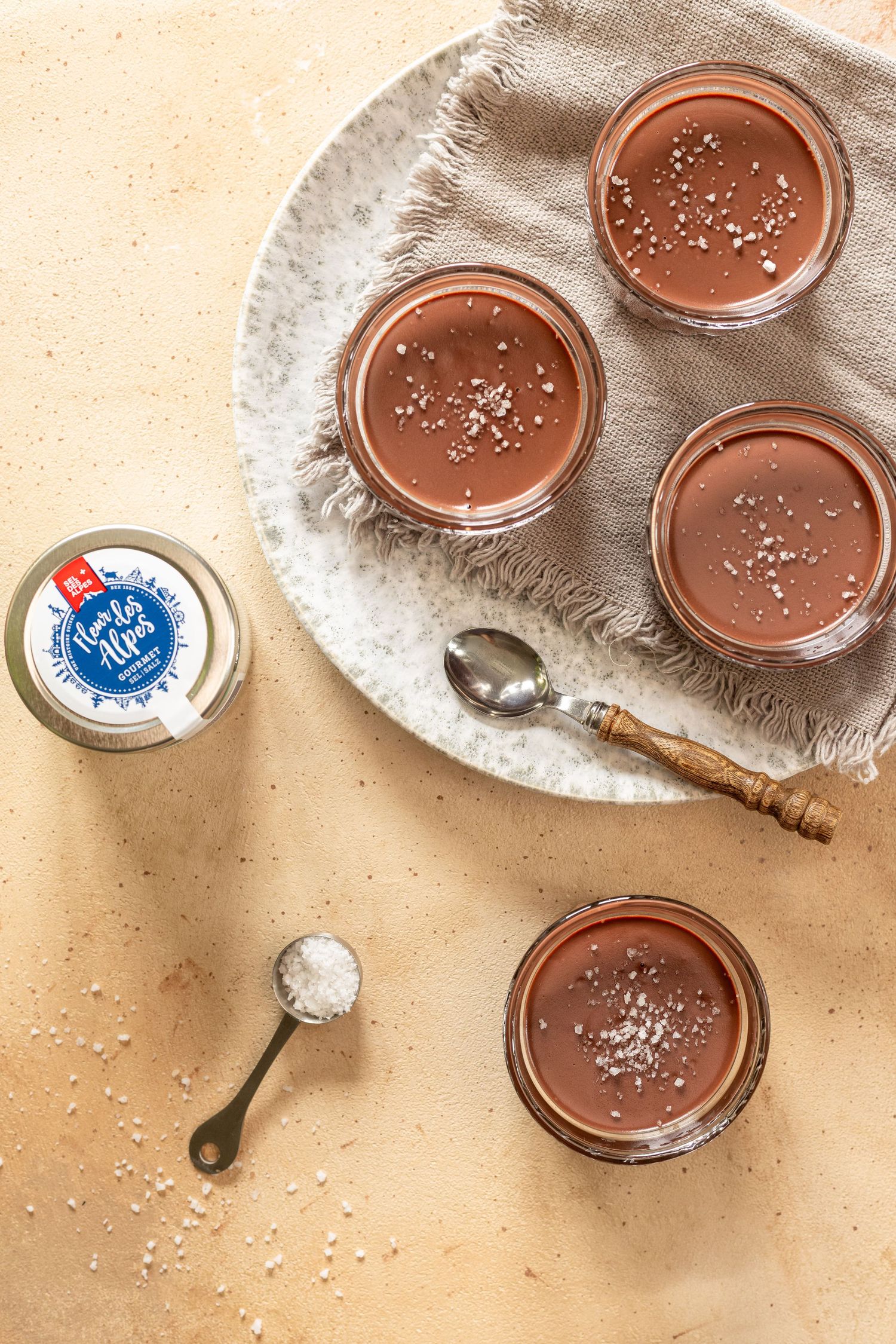 Close-up of chocolate mousse desserts in glass bowls with smooth and textured surfaces.
