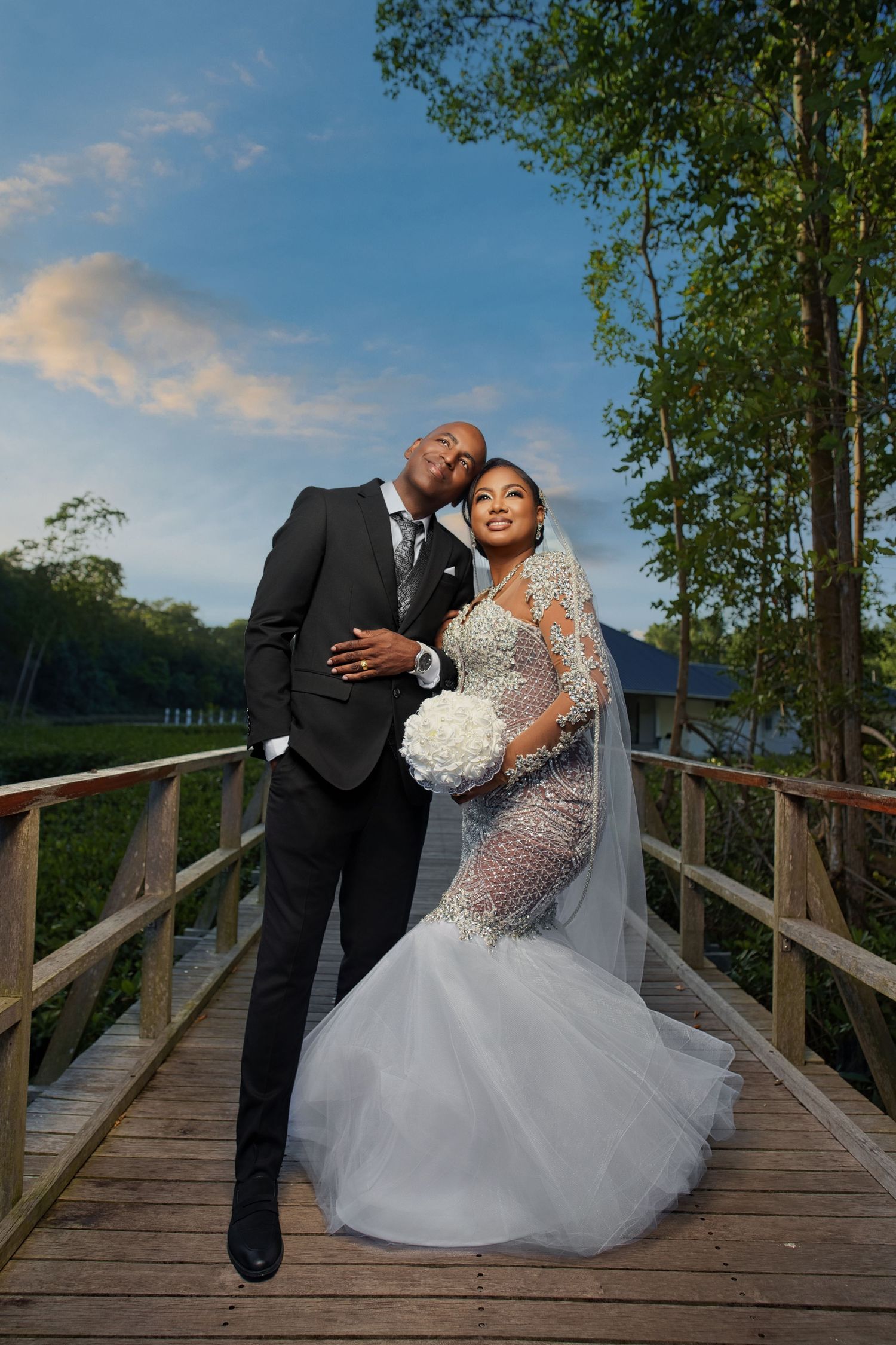 A romantic black and white wedding photo sequence showing a tender kiss between newlyweds through a delicate veil.